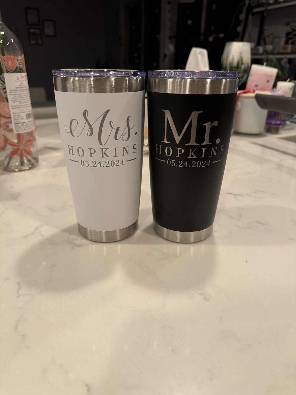 White and black tumblers engraved with Mrs. and Mr. Hopkins and a wedding date.
